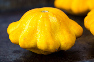 One pattypan is variety of summer squash (Cucurbita pepo) notable for its small size, round and shallow shape, scalloped edges, somewhat resembling small toy top, or flying saucer on dark background