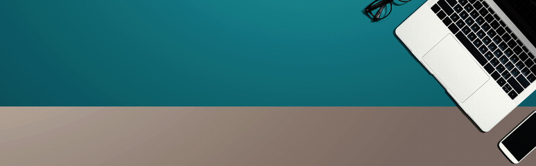 Obraz premium Laptop computer with glasses and phone from above