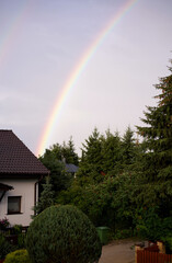 rainbow over a building in the countryside