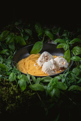 Vanilla ice cream with mango sauce on rustic background