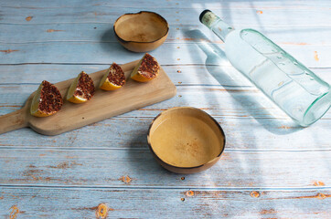 bottle of crystalline tequila or mezcal with jicaras