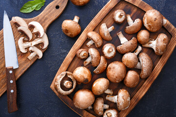 Composition with raw mushrooms on dark background