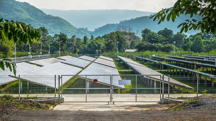 Solar power panels station with outdoor landscape background. Environment electricity renewable sun energy. Photovoltaic eco-green technology research saving. Business battery cell array clean system.