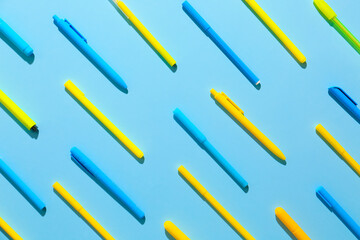 Pens and markers on color background