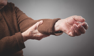 Elderly woman having pain in elbow.