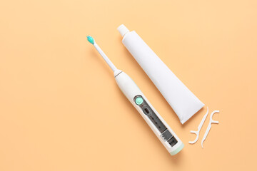 Electric tooth brush and paste on color background