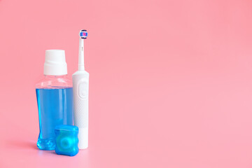 Electric tooth brush and rinse on color background