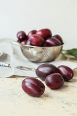 Tasty sweet plums on light table