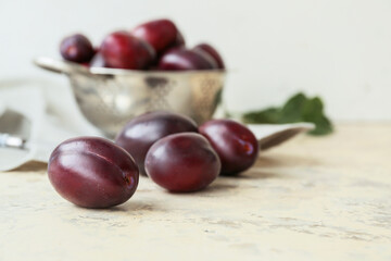 Tasty sweet plums on light table