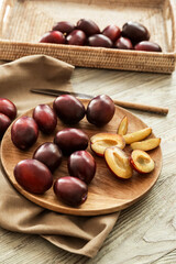 Plate with tasty sweet plums on table