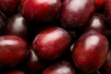 Tasty sweet plums as background