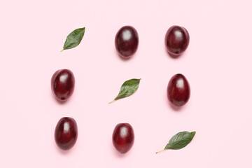 Tasty sweet plums on color background