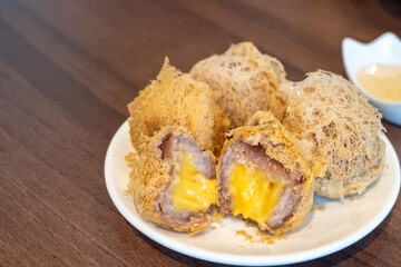 Fried Taro with Salted Egg Cream in a white plate.