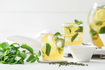 Glass of tasty cold ice tea on table