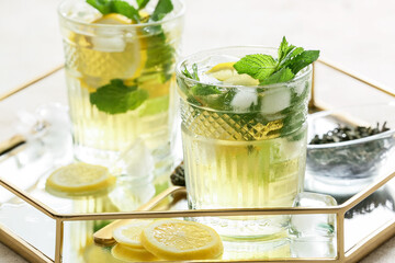 Glasses of tasty cold ice tea on tray