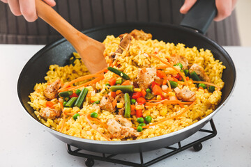 Woman cooking tasty fried rice, closeup