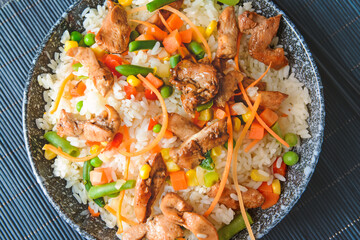 Bowl with tasty fried rice on table, closeup