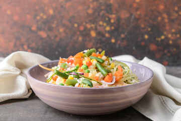 Bowl with tasty fried rice on table