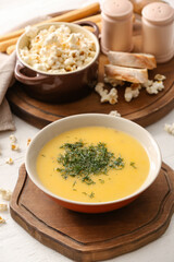 Bowl with tasty popcorn soup on table