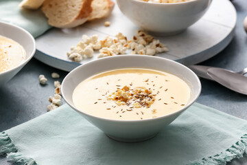 Bowl with tasty popcorn soup on table