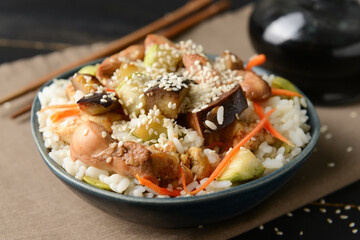 Bowl with tasty fried rice on table