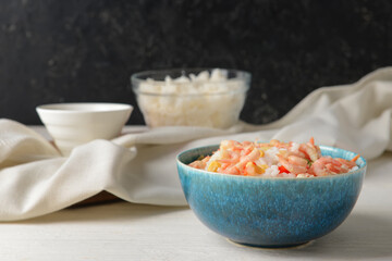 Bowl with tasty fried rice on table