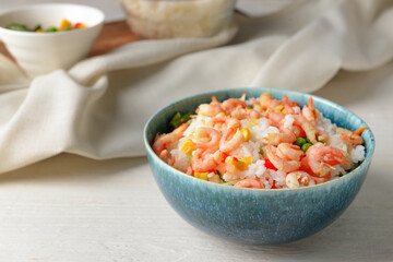 Bowl with tasty fried rice on table