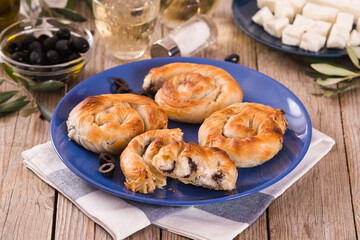 Pastry swirls with cheese and olive filling.