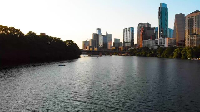 Drone shot of downtown Austin TX. Paddle boarders and kayakers are out enjoying the beautiful weather