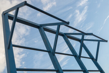 A row of three sections of metal horizontal bars with corner supports with ladder rungs which are...