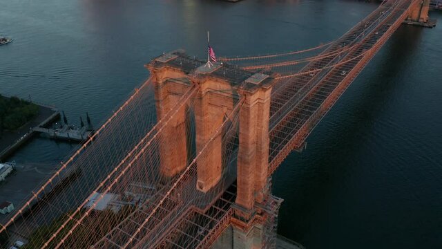 dawn descending and tilting up shot of Brooklyn Bridge