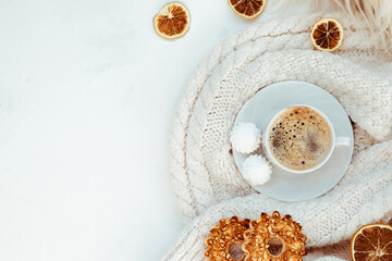 Cup of coffee with meringues and cookies on a white background - top view. Autumn concept with free text space