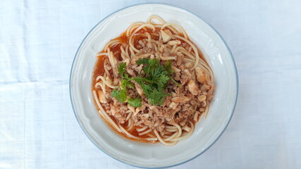 Spaghetti with mushrooms and minced pork on a plate.