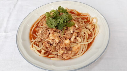 Spaghetti with mushrooms and Minced pork on a plate.