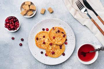 Cottage cheese pancakes with cranberries. Russian syrniki or sirniki, cottage cheese fritters or pancakes on the plate.