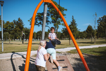 Children having fun with grandmother at the park