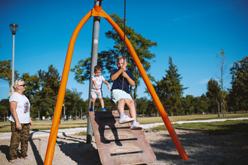 Children having fun with grandmother at the park