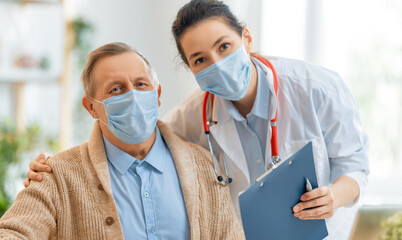 Doctor and senior man wearing facemasks