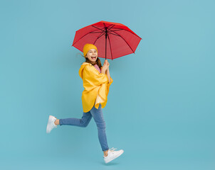 Kid with umbrella on colored background.