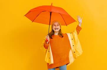 Kid with umbrella on colored background.