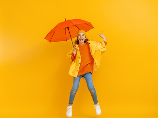 Kid with umbrella on colored background.