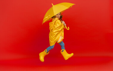 Kid with umbrella on colored background.