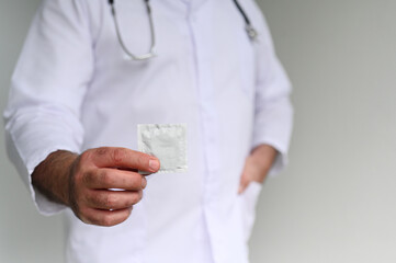 Doctor recommending to use condom to reduce the probability of pregnancy or a sexually transmitted infection