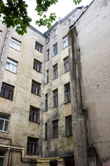 Fototapeta na wymiar Old courtyard in St. Petersburg. Building's facade. Russian architecture