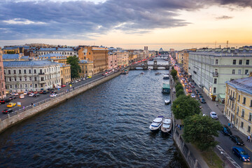 Fototapeta premium Aerial view of the city at sunset in Saint Petersburg, Panorama of the Fontanka River and the bridges across it. View of the city from above. Cities of Russia. Petersburg in the summer.