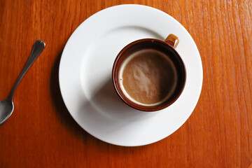cup of coffee on wooden table