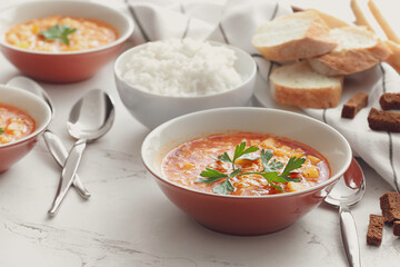 Bowl of tasty rice soup on table