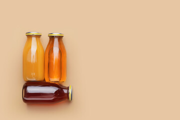 Bottles of juices on color background