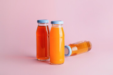 Bottles of juices on color background
