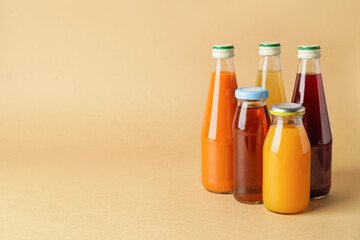 Bottles of juices on color background